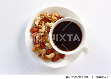 Coffee and mixed nuts on white background Coffee and mixed nuts on white background 121680873