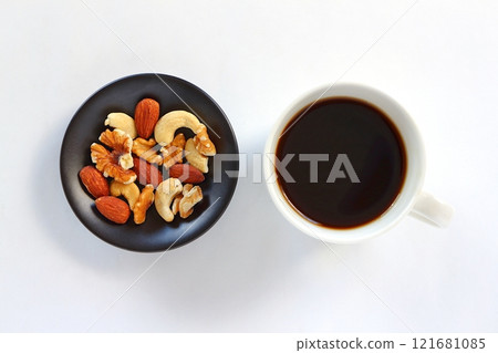 Coffee and mixed nuts on white background Coffee and mixed nuts on white background 121681085