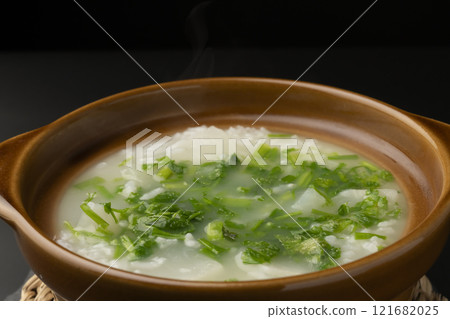 Seven-herb rice porridge cooked in a clay pot. Photograph of the clay pot. Seven-herb rice porridge cooked in a clay pot. Photograph of the clay pot. 121682025