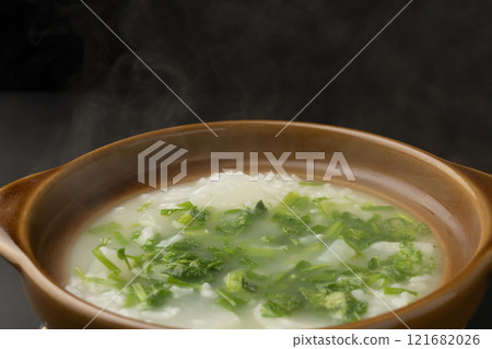 Seven-herb rice porridge cooked in a clay pot. Photograph of the clay pot. Seven-herb rice porridge cooked in a clay pot. Photograph of the clay pot. 121682026