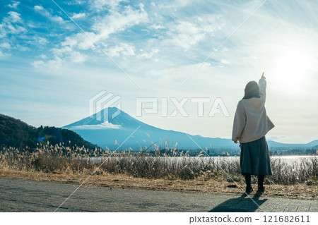 Lake Kawaguchi, Mt. Fuji, back view of a woman pointing at the sky Lake Kawaguchi, Mt. Fuji, back view of a woman pointing at the sky 121682611