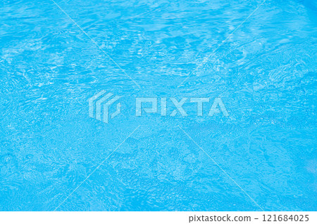 Serene blue water surface with gentle ripples and a soft sun glow Serene blue water surface with gentle ripples and a soft sun glow 121684025