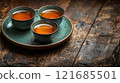 Warm cups of tea on a rustic wooden table create a cozy atmosphere in a serene setting 121685501