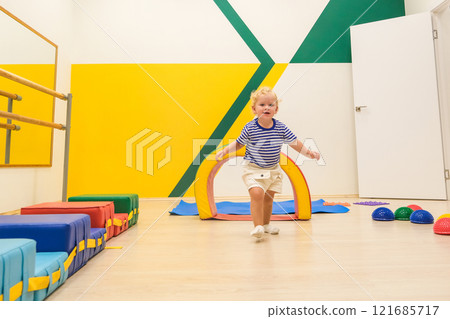 Beautiful blonde baby girl playing in kindergarten Beautiful blonde baby girl playing in kindergarten 121685717