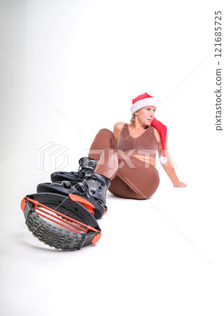 Girl in a New Year's hat and Stylish kangoo shoes 121685725