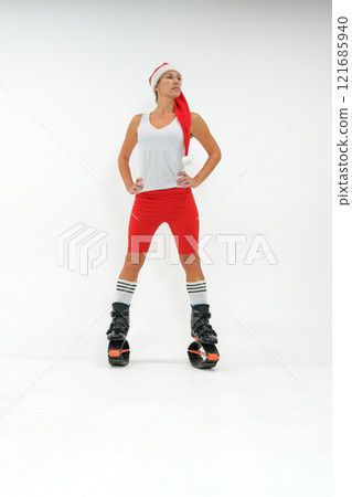 Girl in a New Year's hat and Stylish kangoo shoes 121685940