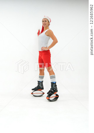 Girl in a New Year's hat and Stylish kangoo shoes Girl in a New Year's hat and Stylish kangoo shoes 121685962