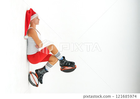 Girl in a New Year's hat and Stylish kangoo shoes Girl in a New Year's hat and Stylish kangoo shoes 121685974