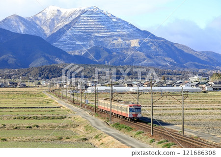 Sangi Railway 801 series train running at the foot of snow-capped Mt. Fujiwara 121686308