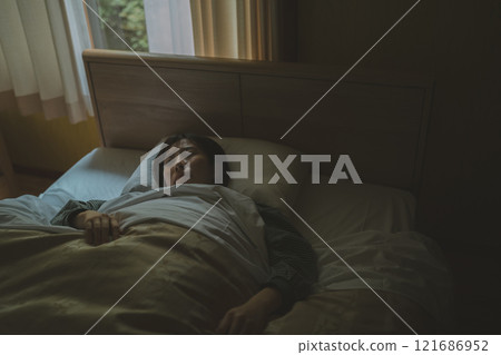 A young woman sleeping in bed A young woman sleeping in bed 121686952
