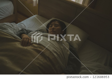 A young woman sleeping in bed A young woman sleeping in bed 121686953