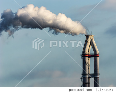 Smoke billowing from a factory chimney - Decarbonization 121687065