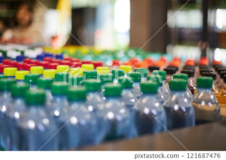 Lot of plastic water bottles with green, yellow, red cap at supermarket shelf Lot of plastic water bottles with green, yellow, red cap at supermarket shelf 121687476