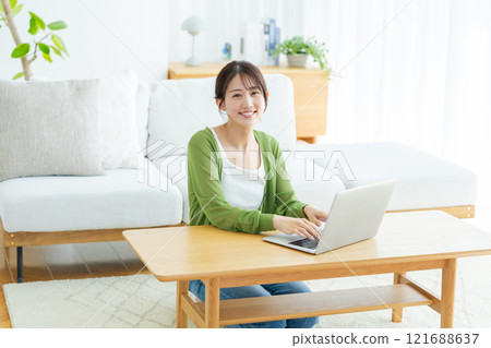 Young woman working on a laptop at home 121688637