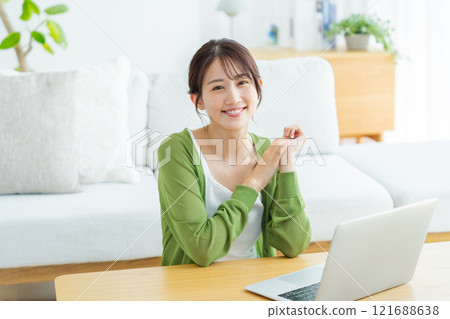 Young woman working on a laptop at home Young woman working on a laptop at home 121688638