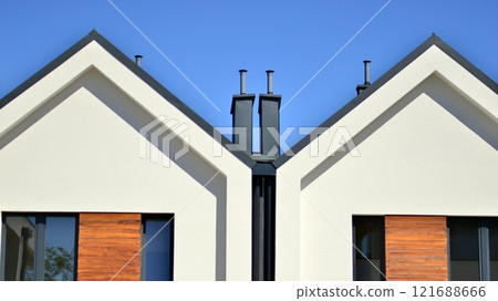 Terraced family homes in newly developed housing estate. The real estate market in the suburbs. New single family houses in a new development area. Residential homes with modern facade.  121688666