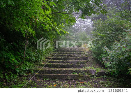 A deserted mountain path covered in fog A deserted mountain path covered in fog 121689241