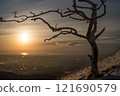 Rime-covered trees and mountain ranges at dusk in winter 121690579