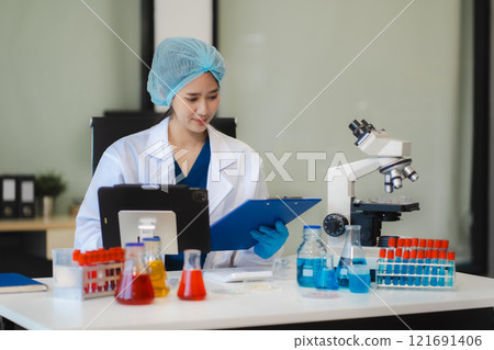 Female biotechnologist testing new chemical substances in a laboratory. 121691406
