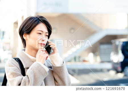 A woman talking on a smartphone 121691670