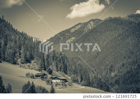 Wonderful wooded mountain alpine panorama with village and huts Austria. Wonderful wooded mountain alpine panorama with village and huts Austria. 121691725