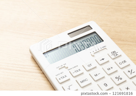 A calculator with 1,030,000 displayed on a table A calculator with 1,030,000 displayed on a table 121691816