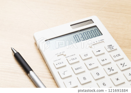 A calculator with 1,030,000 displayed on a table 121691884