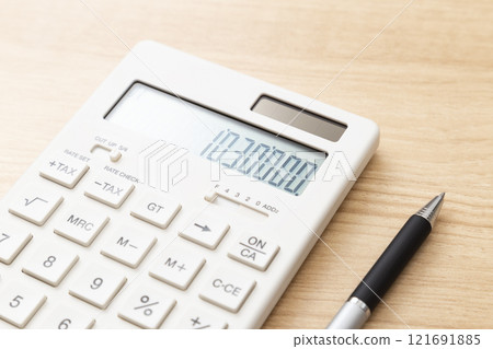 A calculator with 1,030,000 displayed on a table A calculator with 1,030,000 displayed on a table 121691885