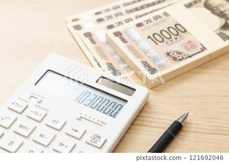 1,030,000 yen and a calculator on the table 121692046