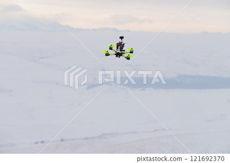 flying homemade drone with bright details on the body in abstract winter environment, close-up. hobby for adults flying homemade drone with bright details on the body in abstract winter environment, close-up. hobby for adults 121692370