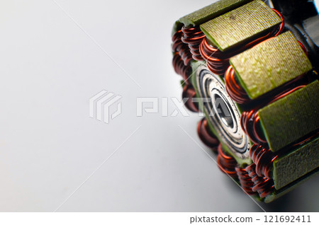 Brushless quadcopter motor core disassembled. Multiple magnetic coils. Copy space. Electronics and drone construction 121692411