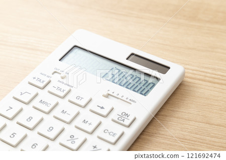 A calculator with 1.3 million displayed on the table A calculator with 1.3 million displayed on the table 121692474