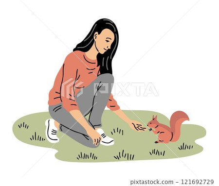 A young woman feeds a squirrel in the park A young woman feeds a squirrel in the park 121692729