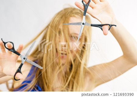 Girl with scissors for haircutting 121693390