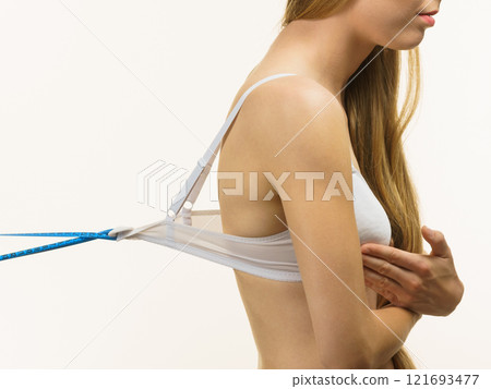 Woman wearing too big bra, loose band Woman wearing too big bra, loose band 121693477