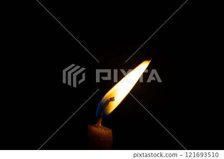 burning candle on black background burning candle on black background 121693510