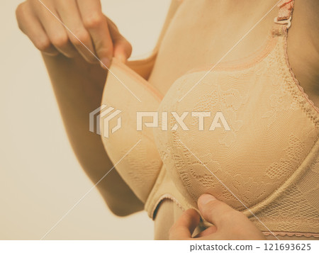 Woman wearing too big bra 121693625