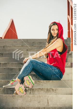 Skate girl on stairs with skateboard. 121693712
