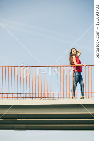 Girl on bridge in city. Girl on bridge in city. 121693733