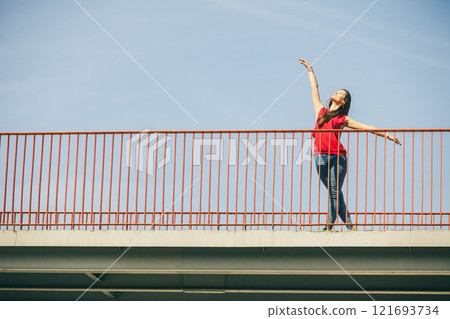 Girl on bridge in city. Girl on bridge in city. 121693734