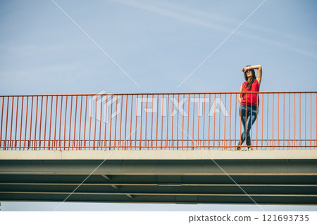 Girl on bridge in city. Girl on bridge in city. 121693735