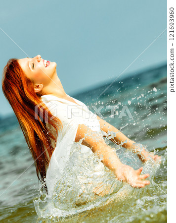 Redhaired happy girl on beach. Redhaired happy girl on beach. 121693960