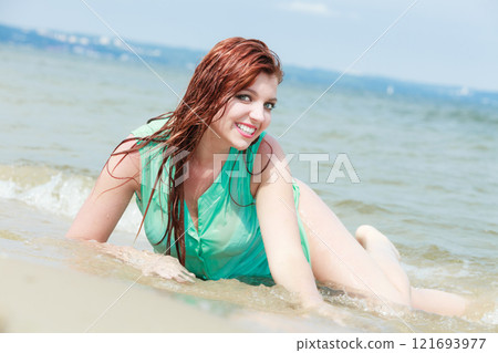 Redhaired happy girl on beach. Redhaired happy girl on beach. 121693977