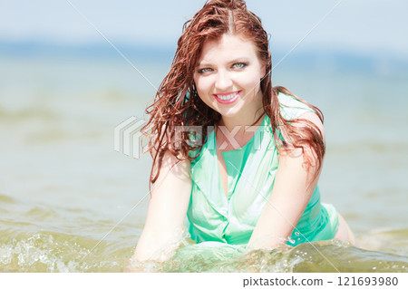 Redhaired happy girl on beach. Redhaired happy girl on beach. 121693980