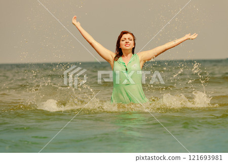 Redhaired happy girl on beach. Redhaired happy girl on beach. 121693981