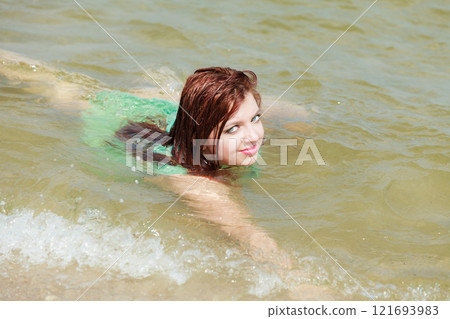Redhaired happy girl on beach. Redhaired happy girl on beach. 121693983
