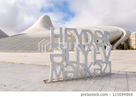 Exploring Heydar Aliyev Center with modern architecture in background and large sign in foreground 121694868