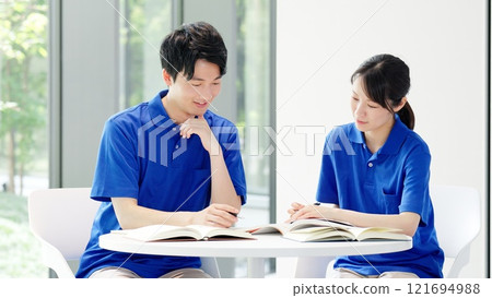 A caregiver studying for a qualification 121694988