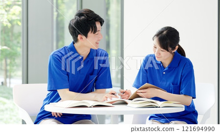 A caregiver studying for a qualification 121694990