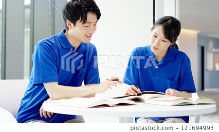 A caregiver studying for a qualification 121694993
